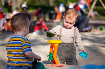 Toddlers playing with infant toddler toys